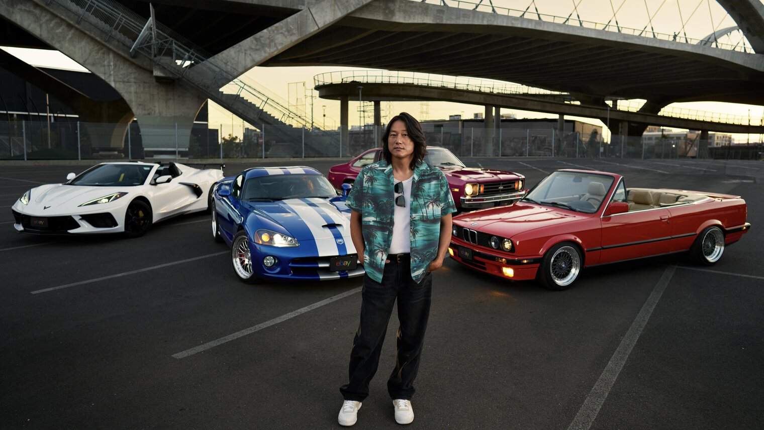 Actor and automotive enthusiast Sung Kang stands in front of eBay's Most Wanted Collection.